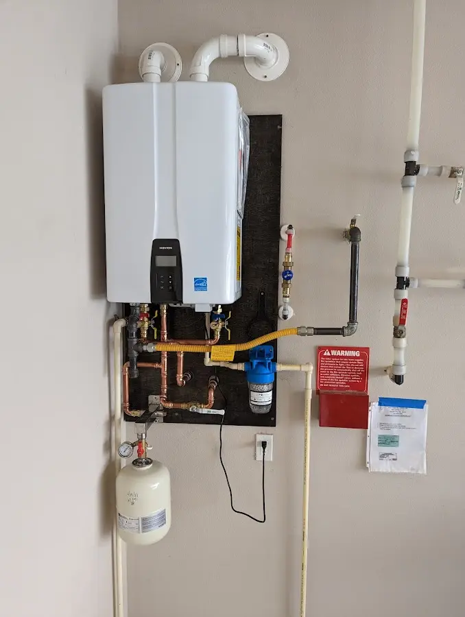 Professional plumber installing copper piping in a Melissa home